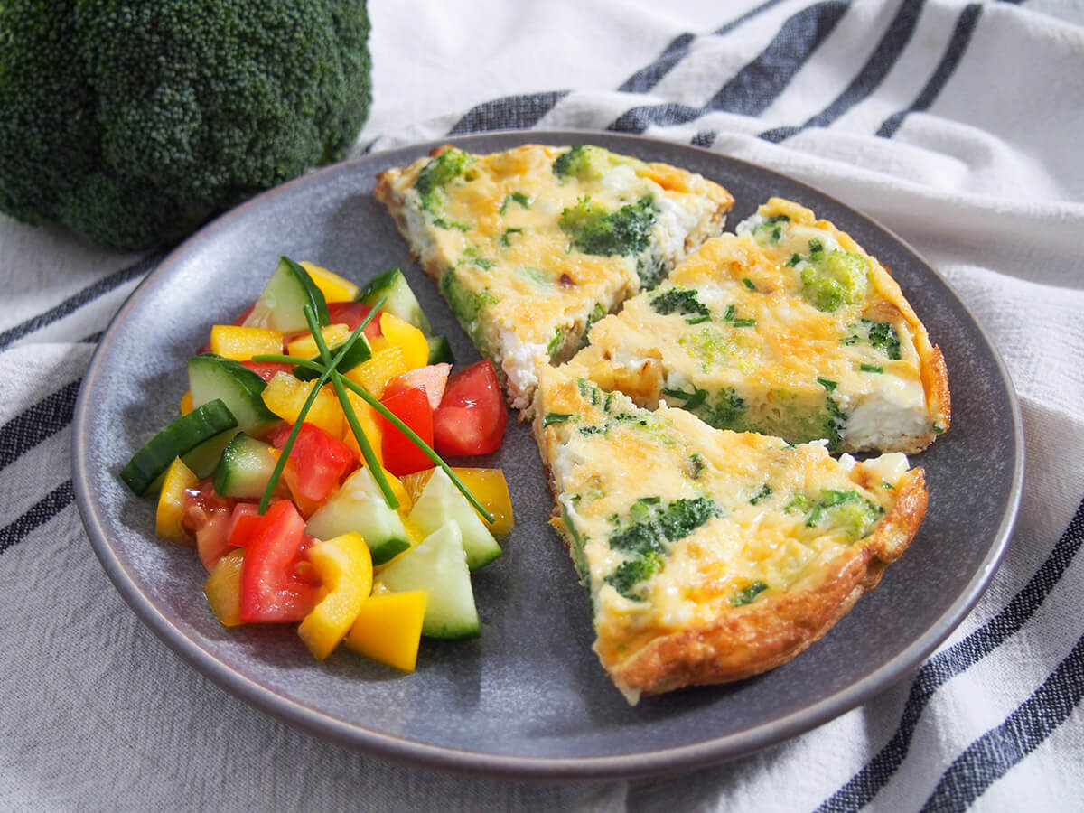 slices of broccoli goat cheese frittata with salad to side