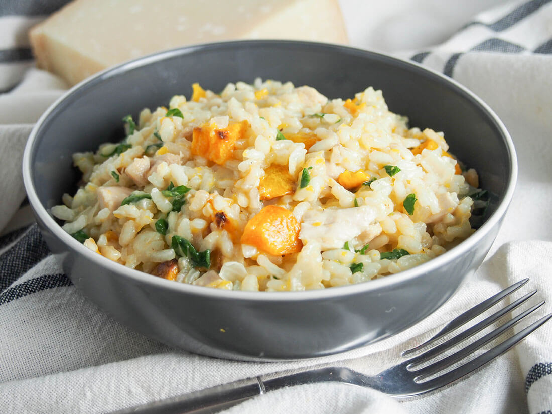 bowl of butternut squash risotto with chicken with fork in front