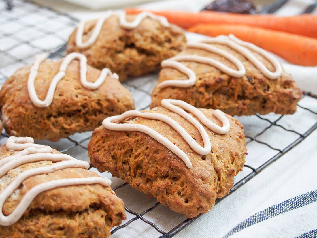 carrot cake scones on rack with carrots behind