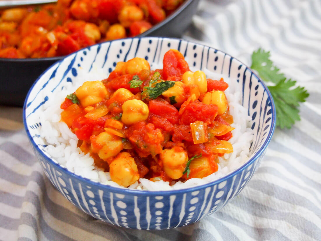 chana masala over rice in a bowl