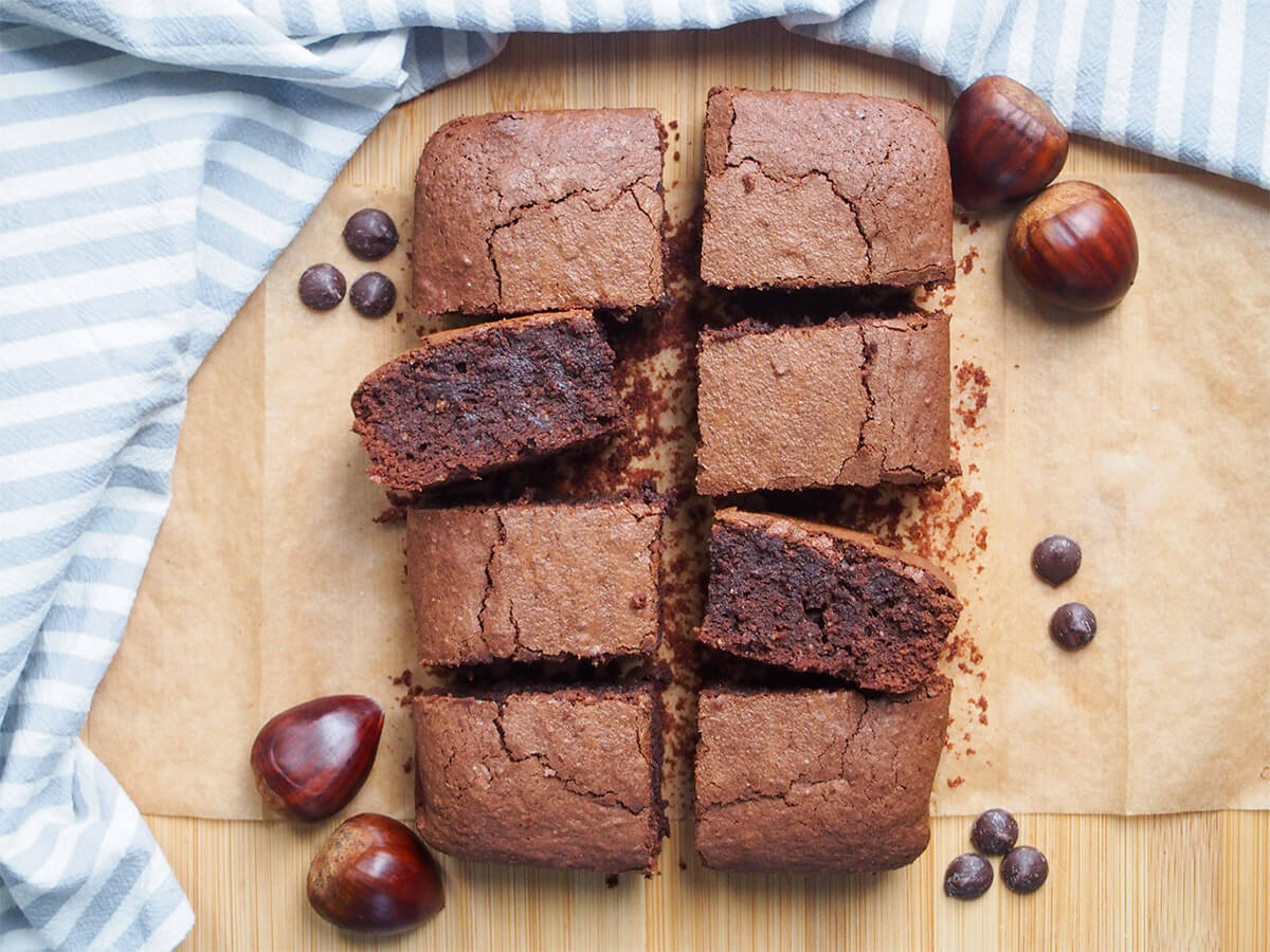 rows of gluten free chestnut brownies with chestnuts to side of them