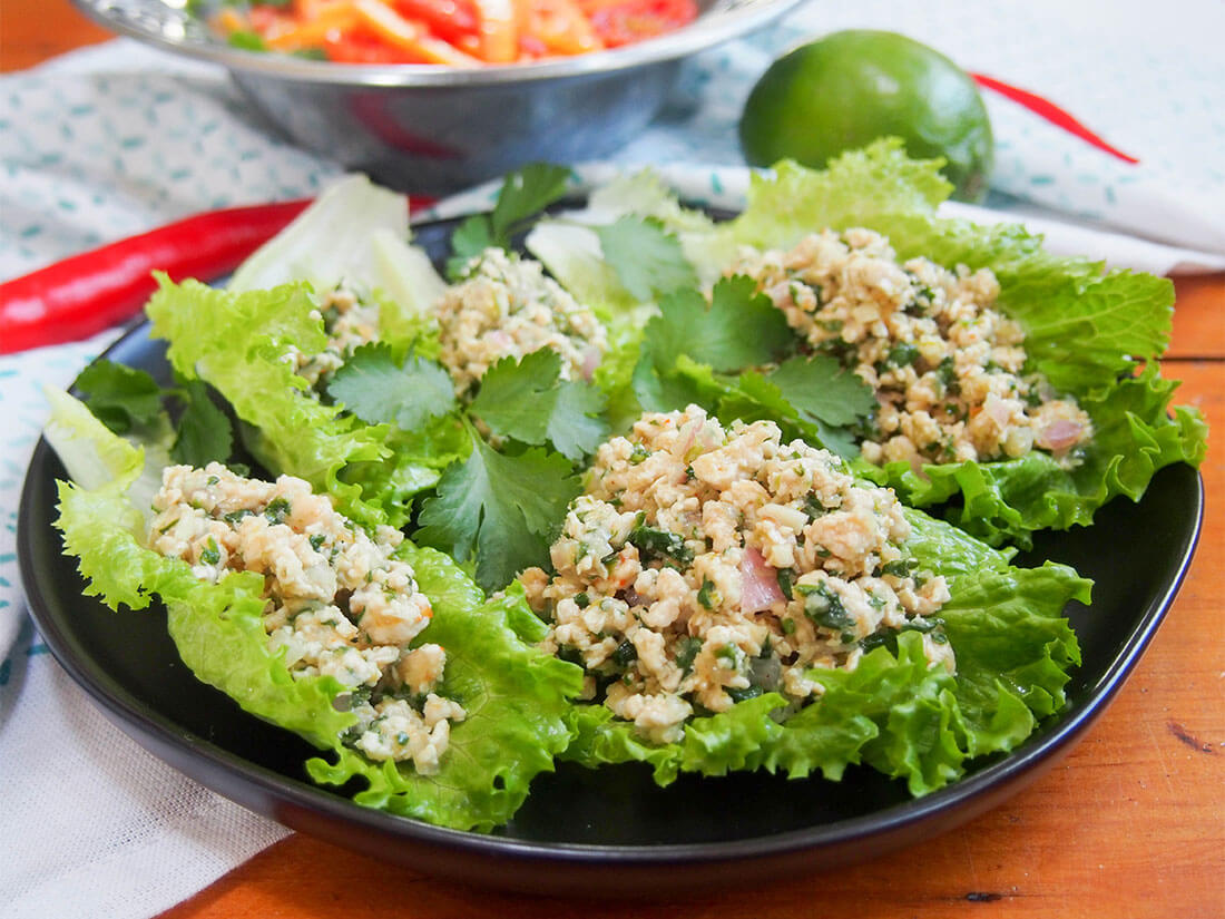 plate of lettuceleaves topped with larp (larb gai, Thai/Laos chicken salad)