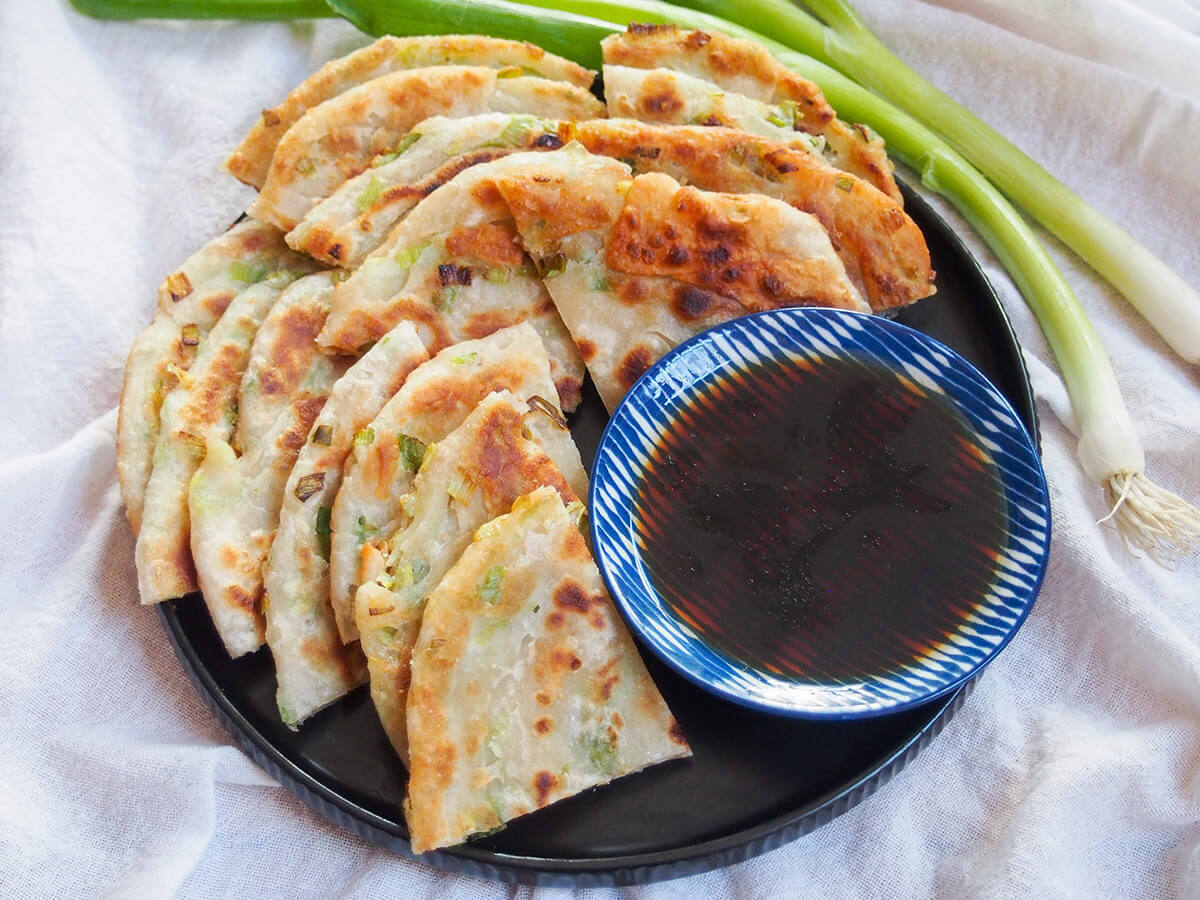 plate of Chinese scallion pancakes with dipping sauce on plate