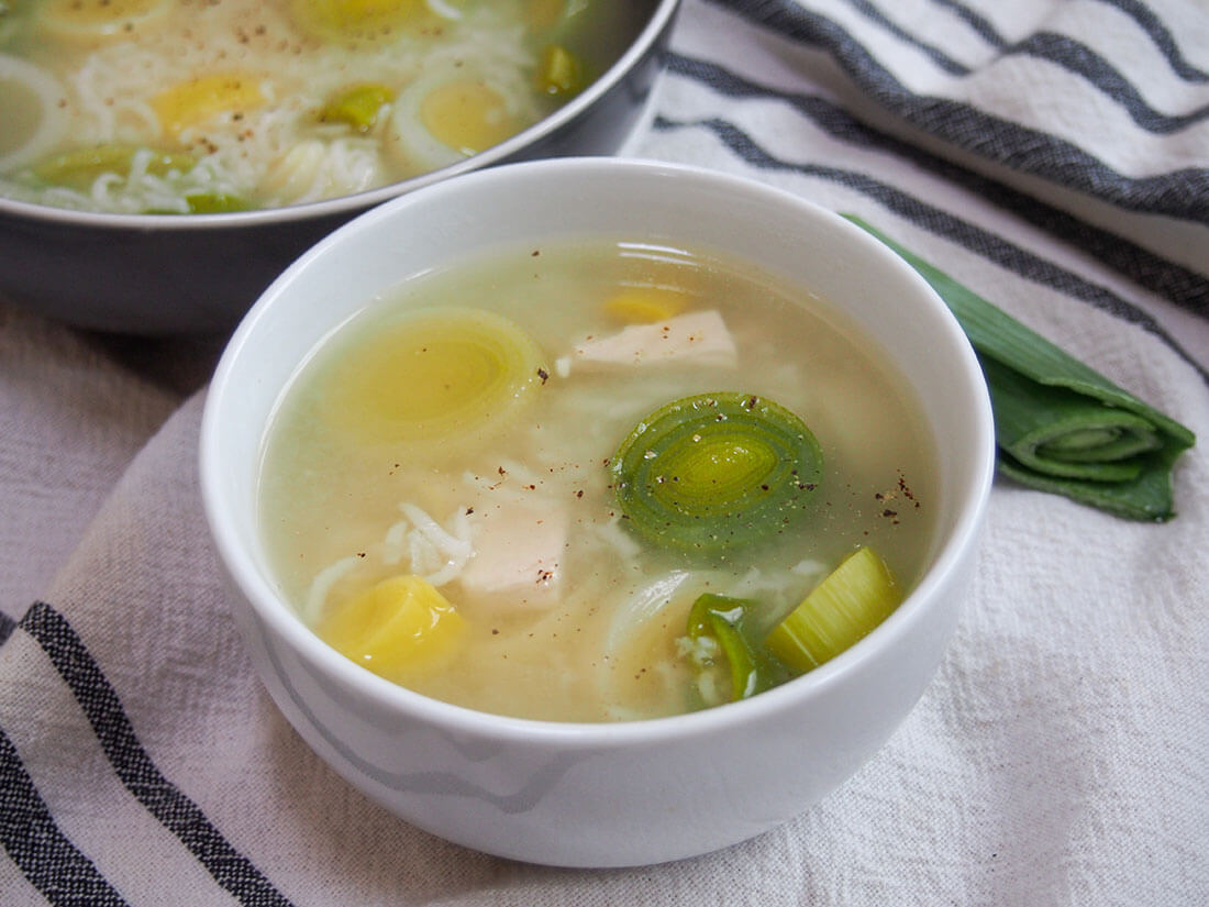 Cock-a-leekie soup in white bowl