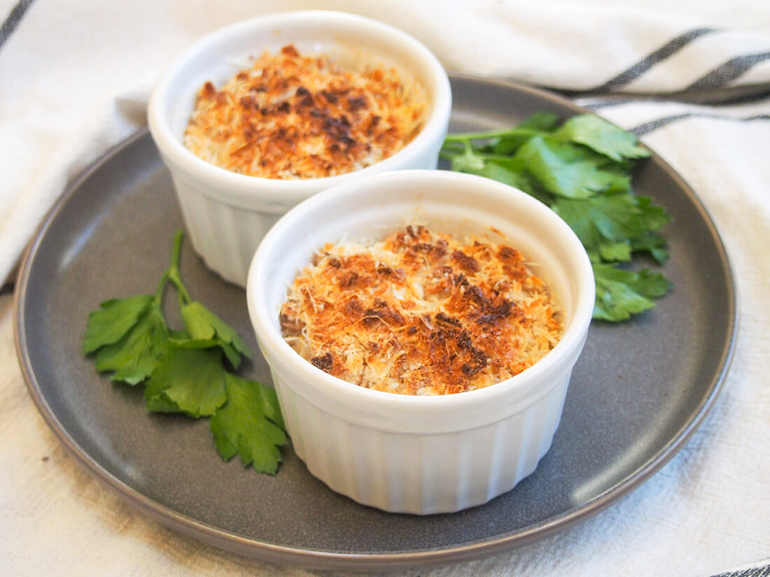 two dishes of Coquille St Jacques (scallop gratin)