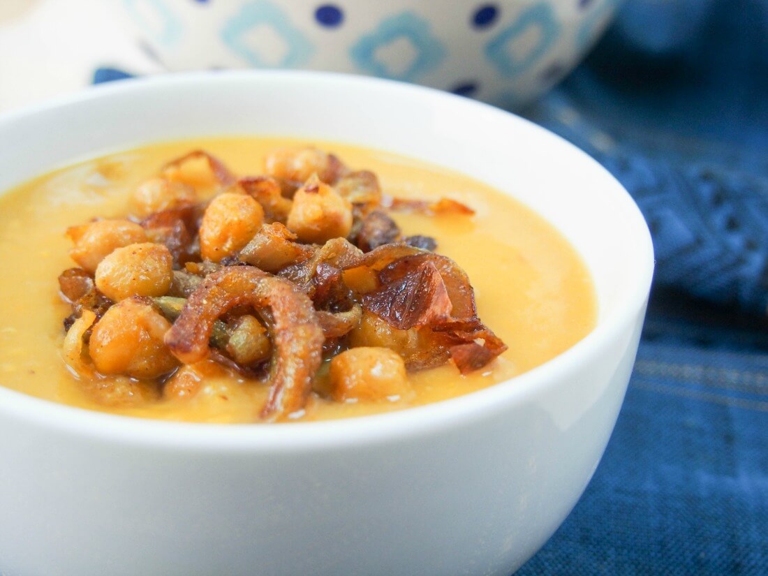 Delicata squash soup with curried chickpeas and onions - close view of bowl from side