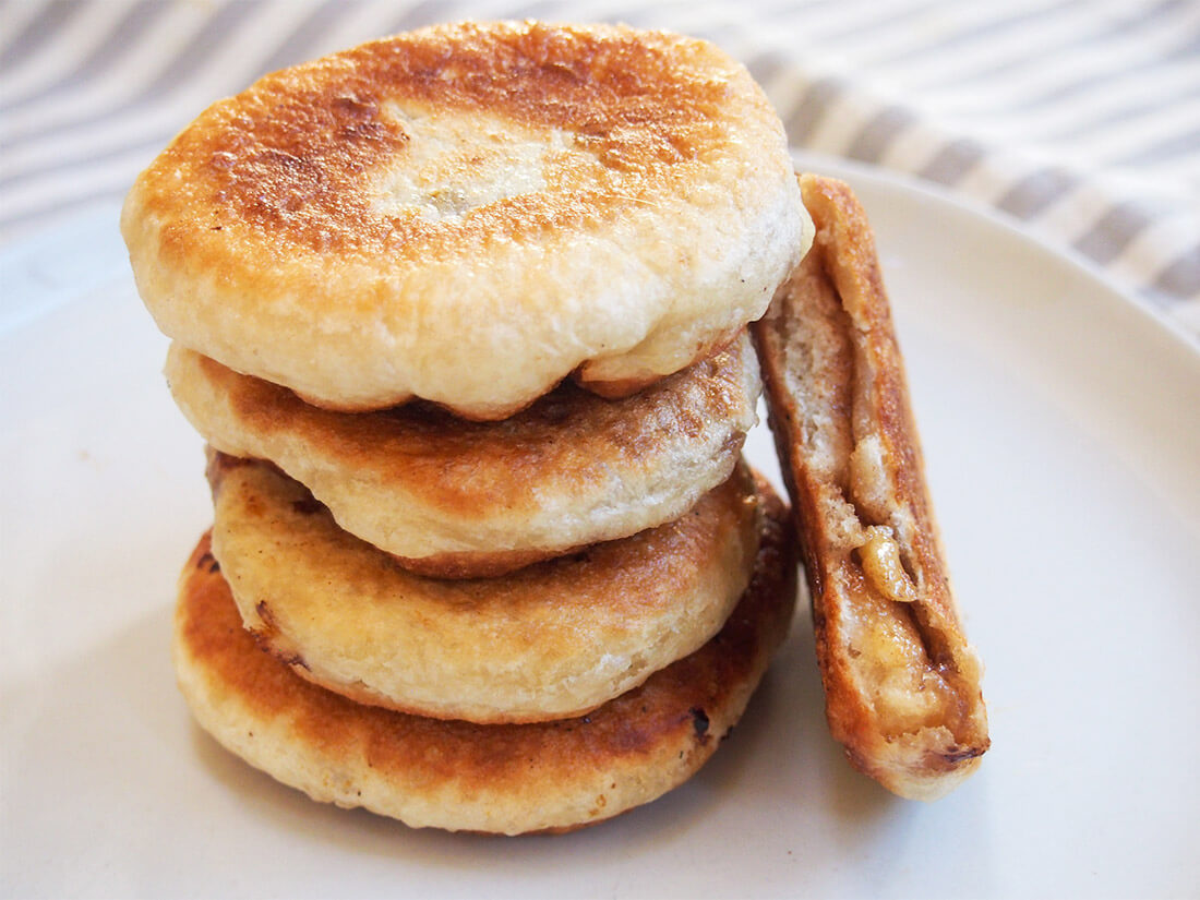 hotteok Korean sweet pancakes in stack with one bitten to side