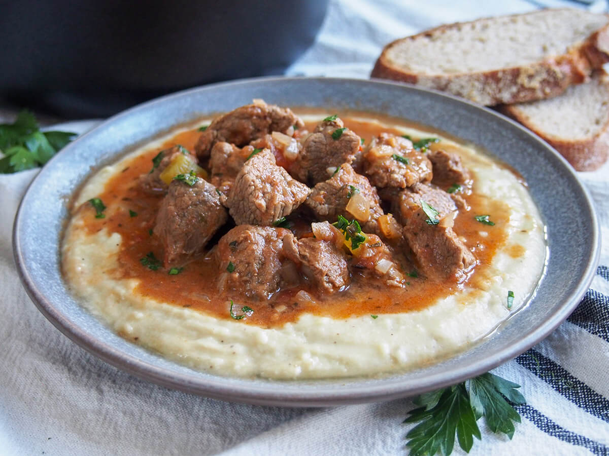 plate of Turkish lamb stew with eggplant bechemel sauce underneath