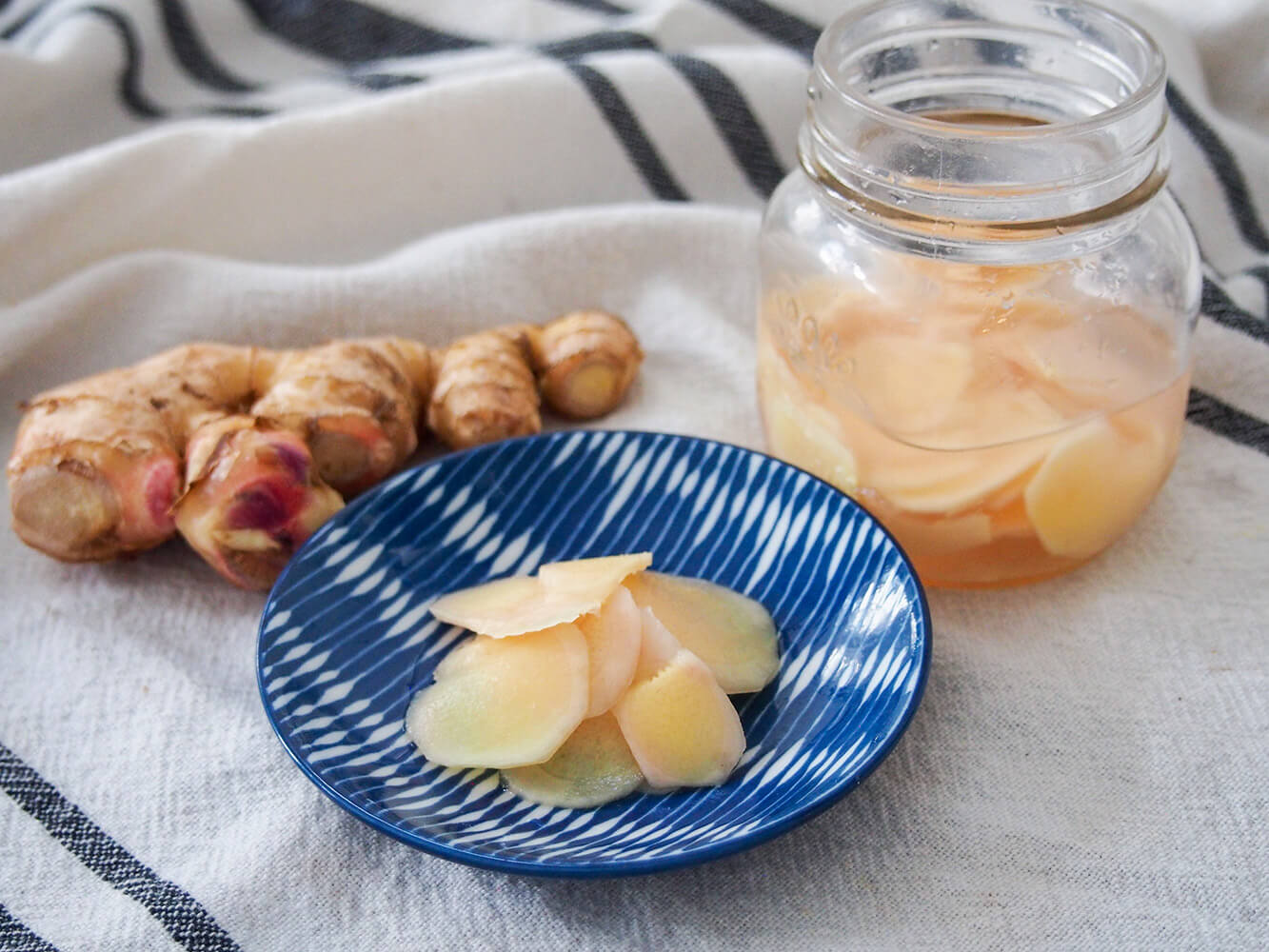 Japanese pickled ginger on small plate with additional in jar to side