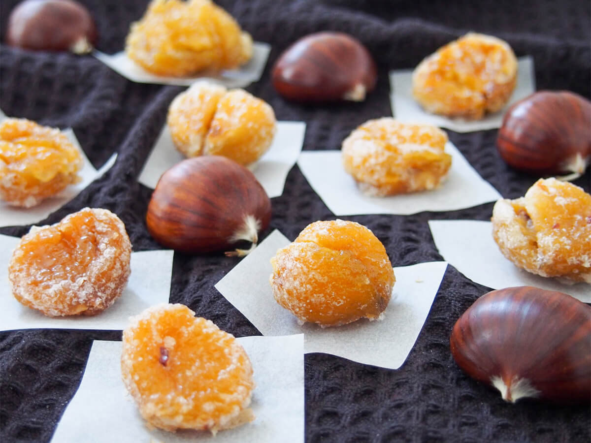 Marron glacé (candied chestnuts) on paper with whole chestnuts in between