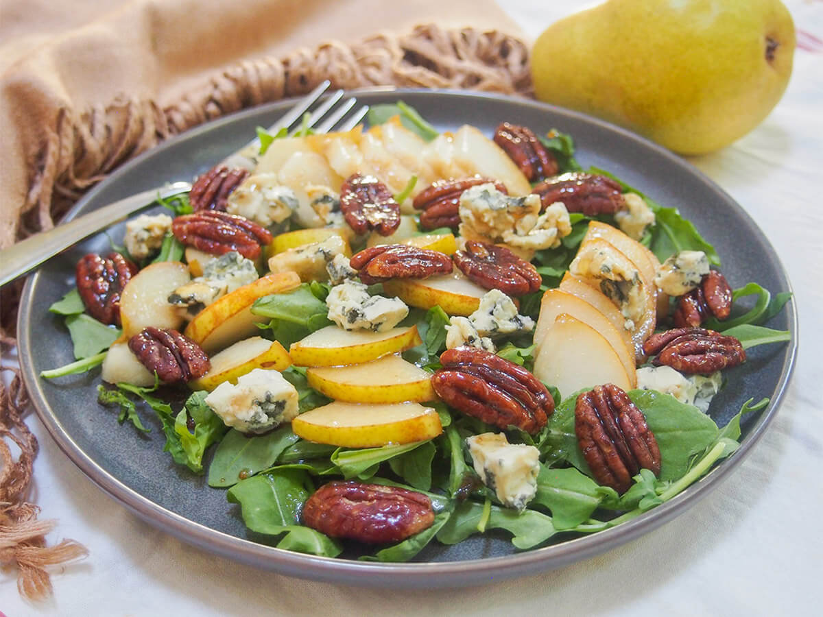 plate of pear gorgonzola salad with fork to back of plate