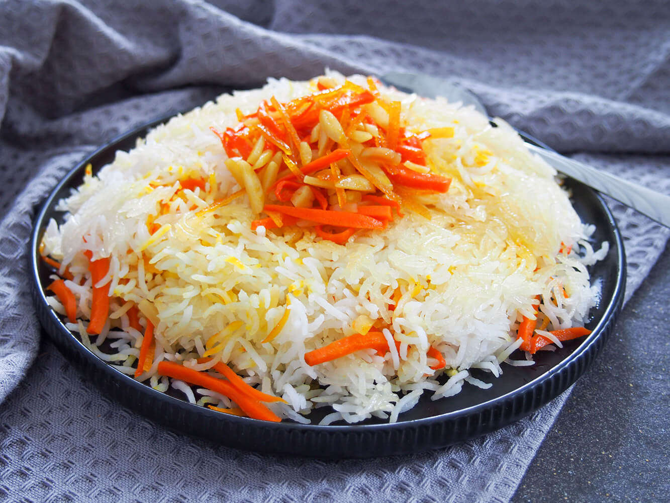 Persian sweet rice (shirin polow) with carrot orange topping