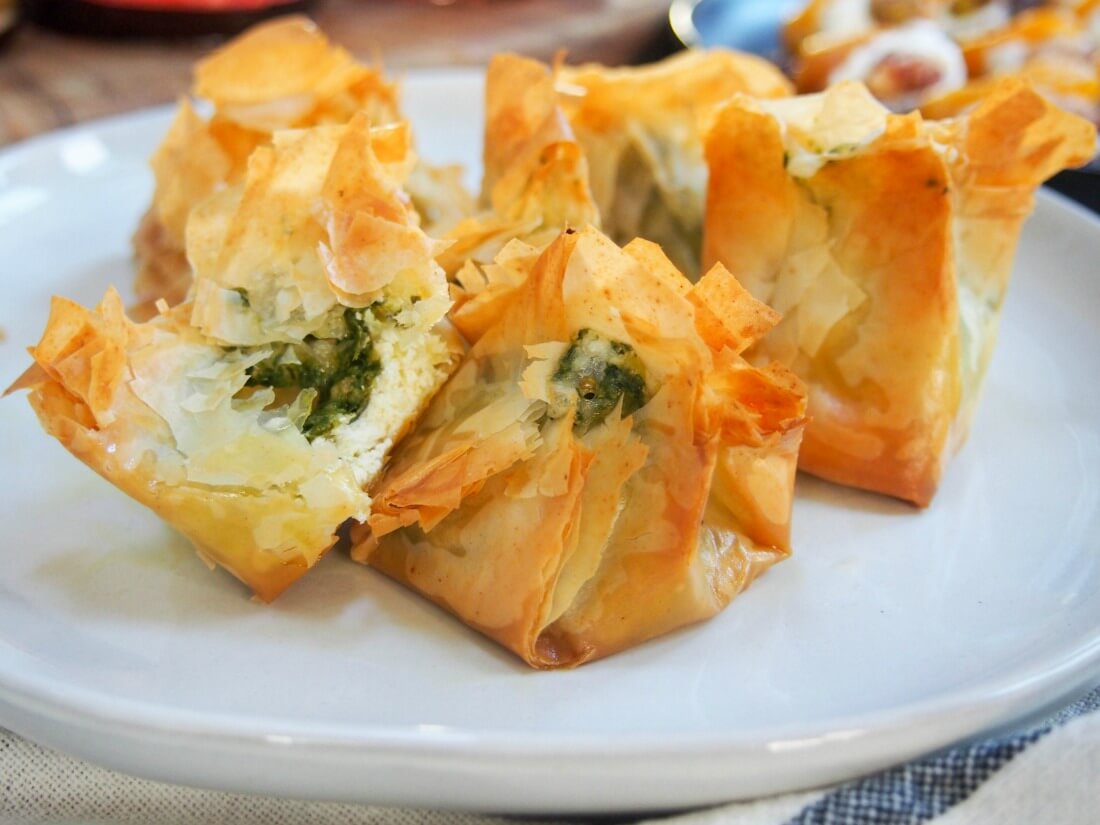 Pesto goats cheese filo parcels with one bitten to side