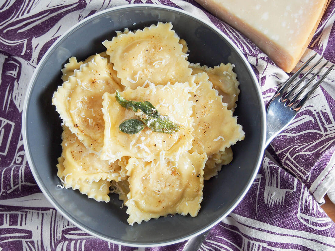 pumpkin ravioli tortelli di zucca in bowl from above with fork to side of bowl