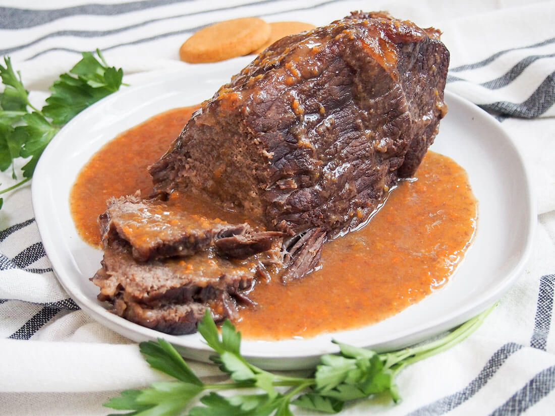 sauerbraten German pot roast on plate with sauce