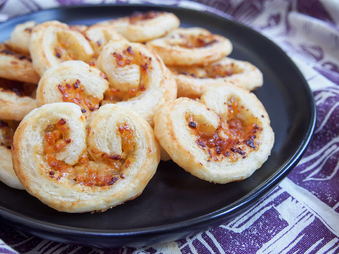 side view of cheese and fig savory palmiers on plate