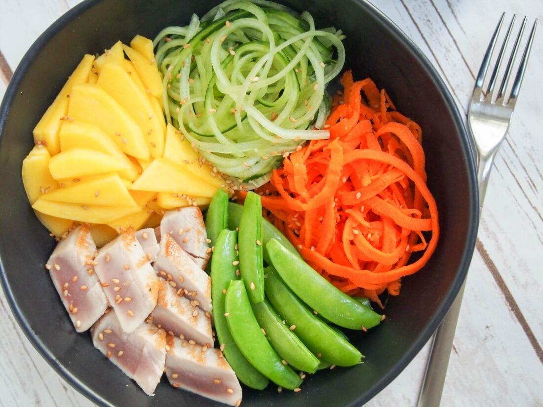 Seared tuna and veggie bowl from overhead with fork to side