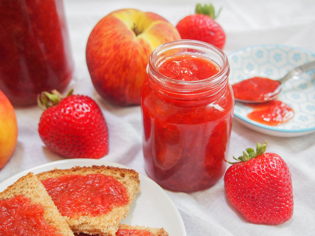 strawberry peach jam in jar and on toast to side