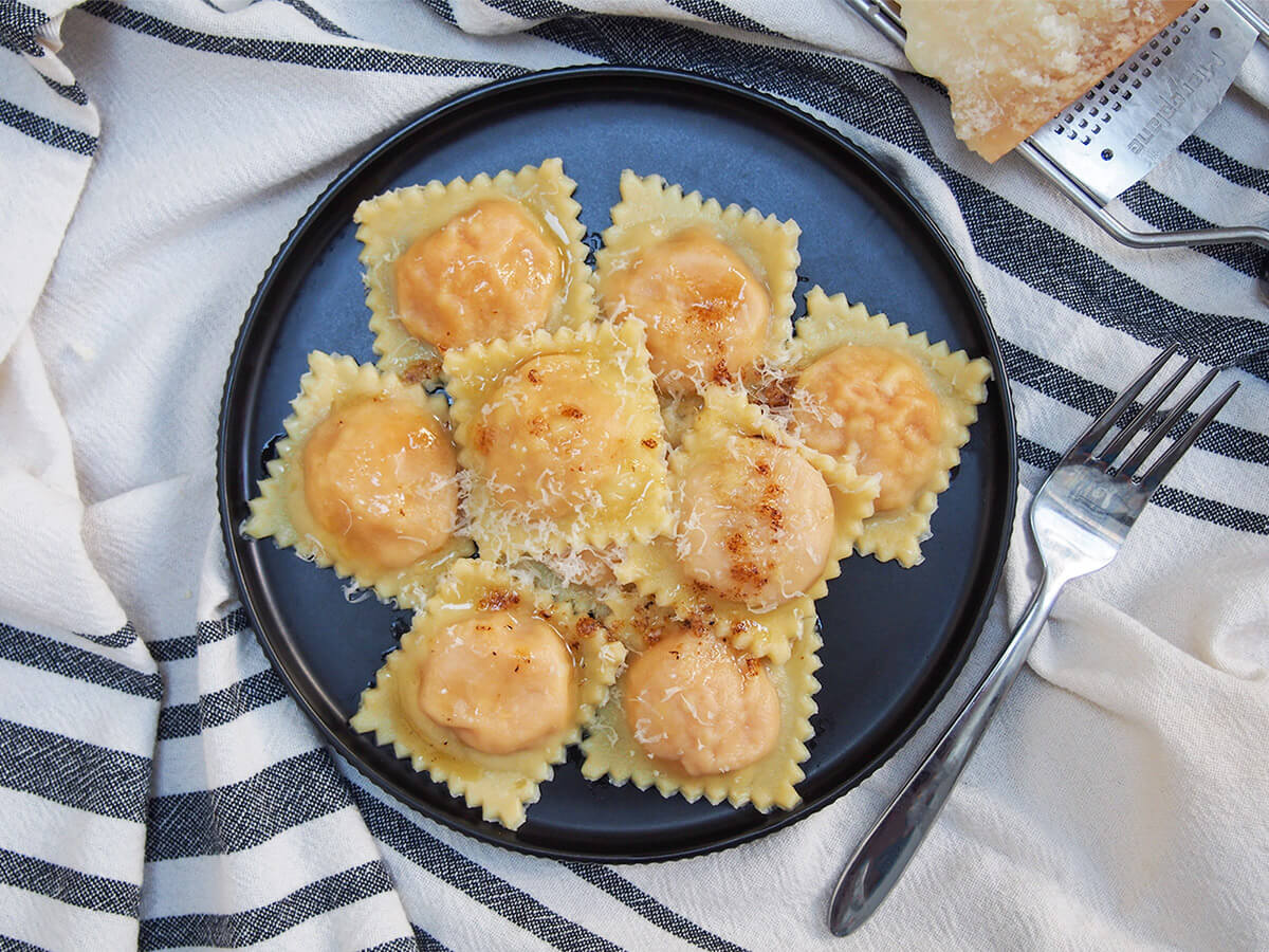 plate of sweet potato ravioli with fork to side